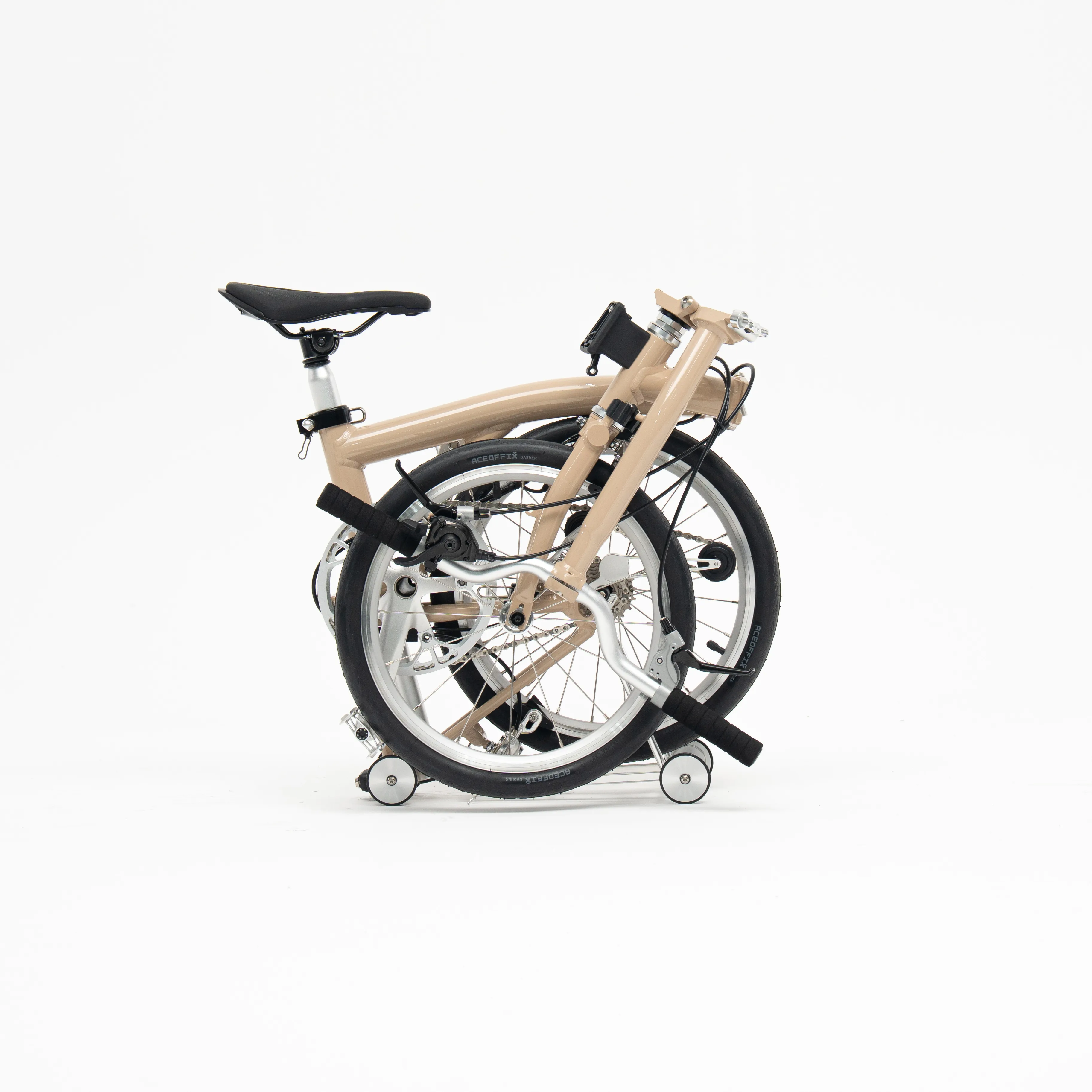 Lumio folding bike in the folded position, Milk Tea colourway — side profile on a white background