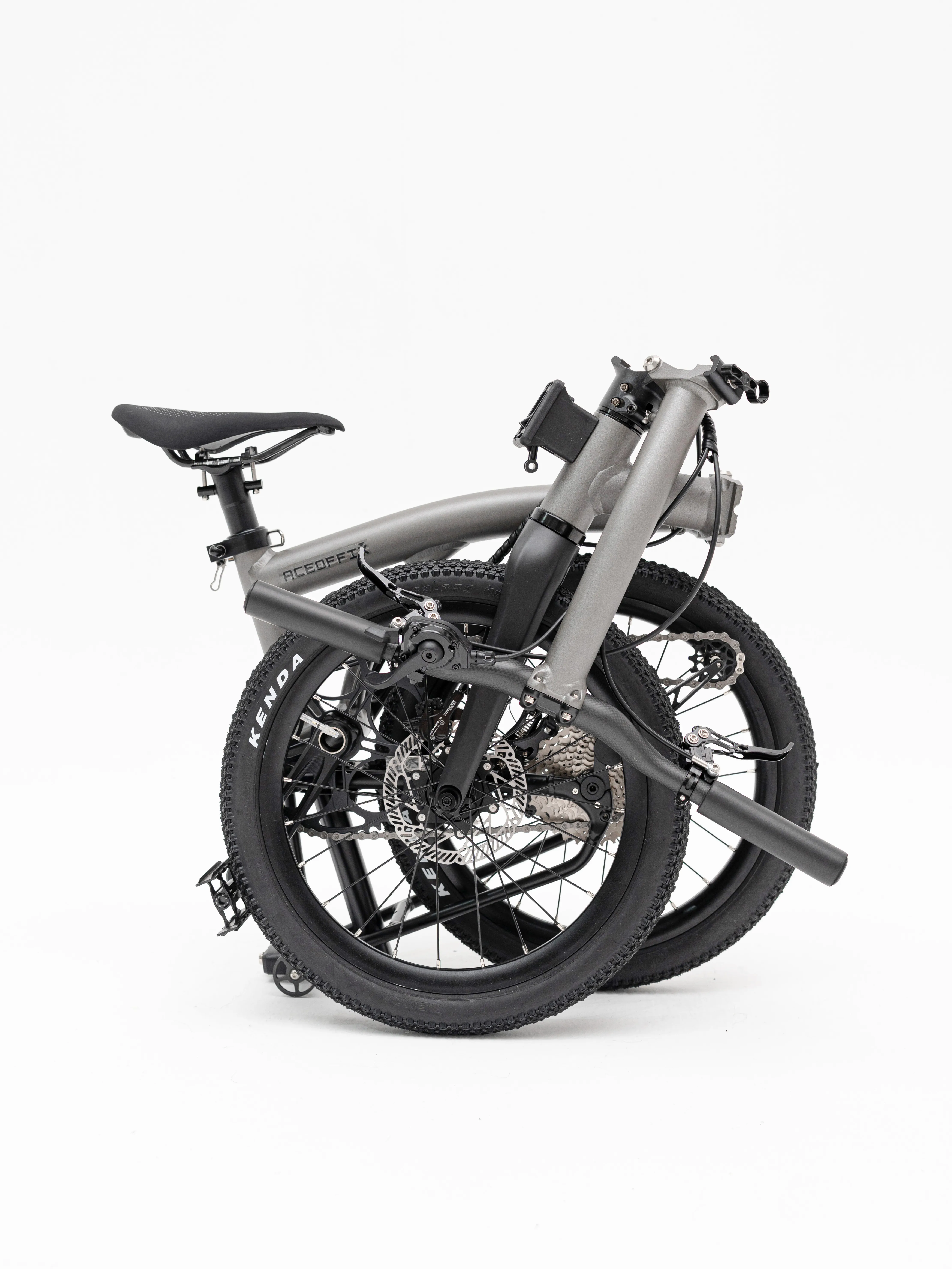 Gravon folding bike in the folded position, Titanium Grey with Kenda 18-inch tyres — rear three-quarter view