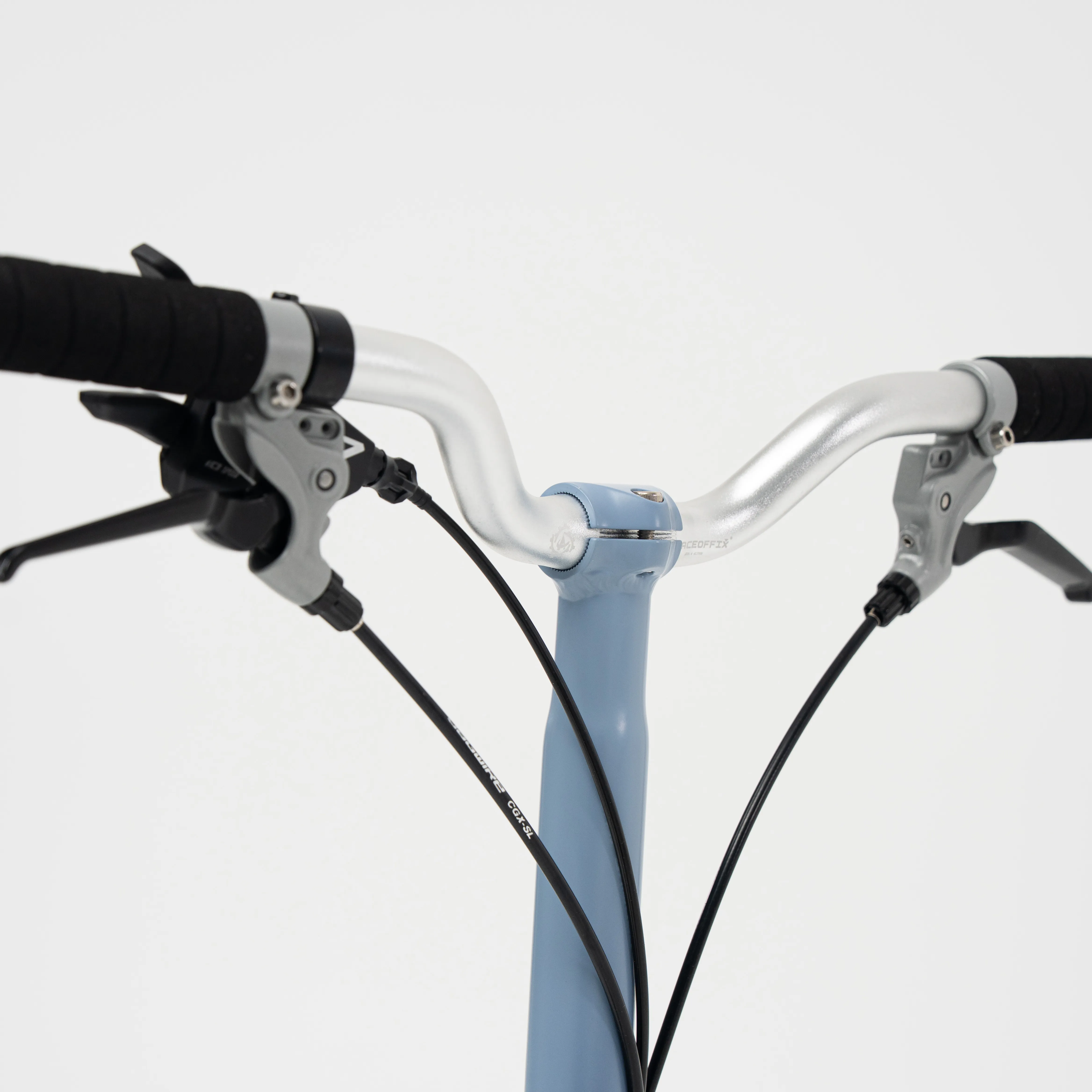 Lumio cockpit detail — H50 alloy M-bar with JAGWIRE hydraulic cabling