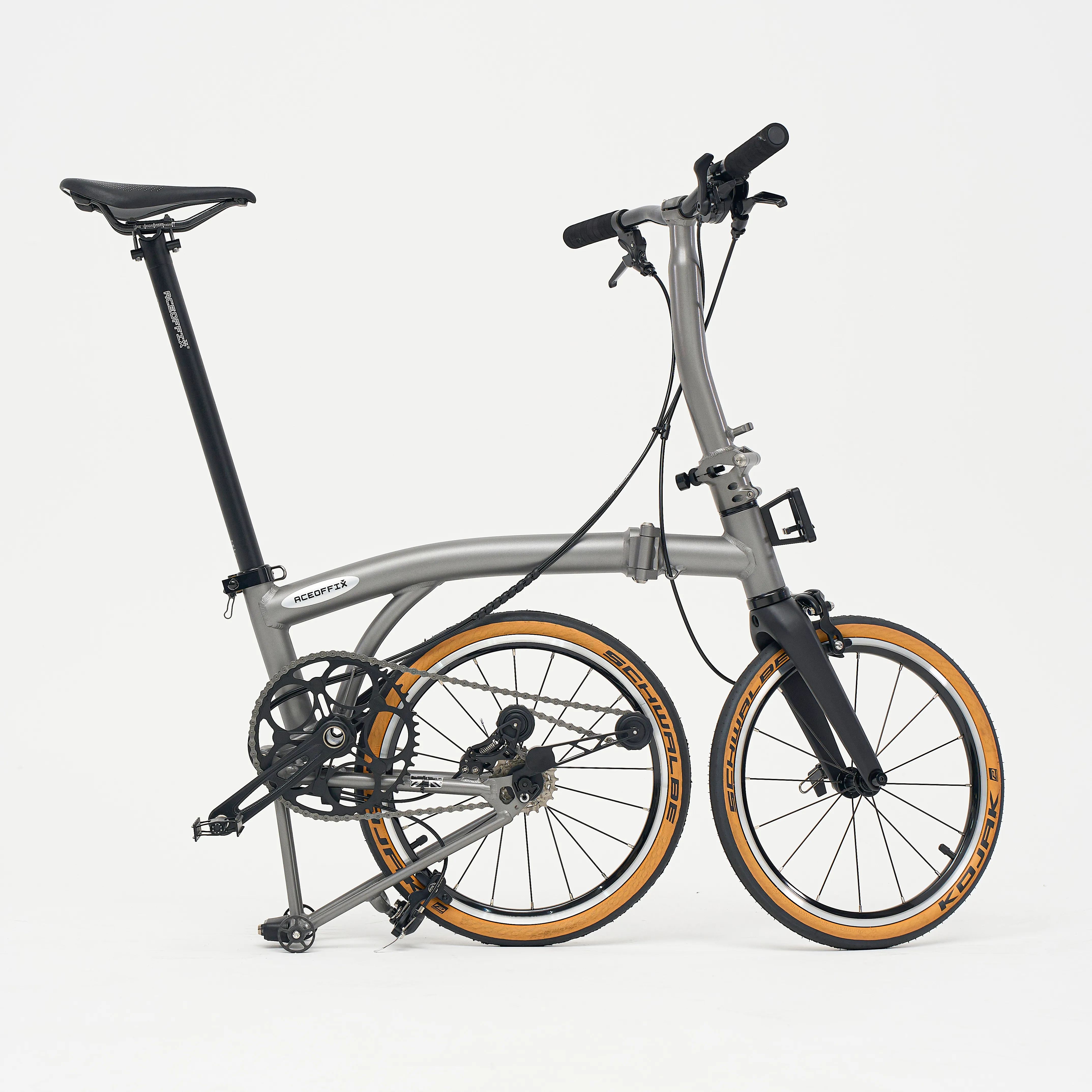 Aerra folding bike unfolded, Titanium Grey — drive-side studio shot with Schwalbe Kojak tan-wall tyres
