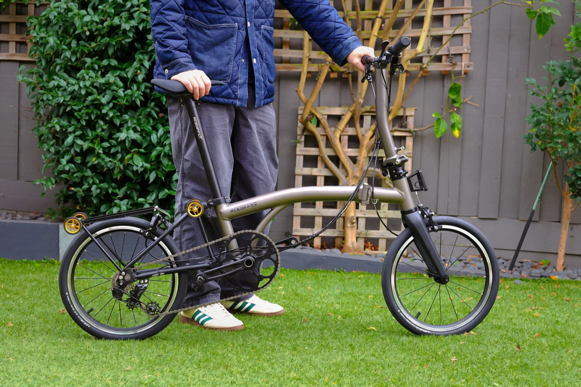 Aerra folding bike unfolded outdoors, Titanium Grey frame and tan-wall tyres in natural light