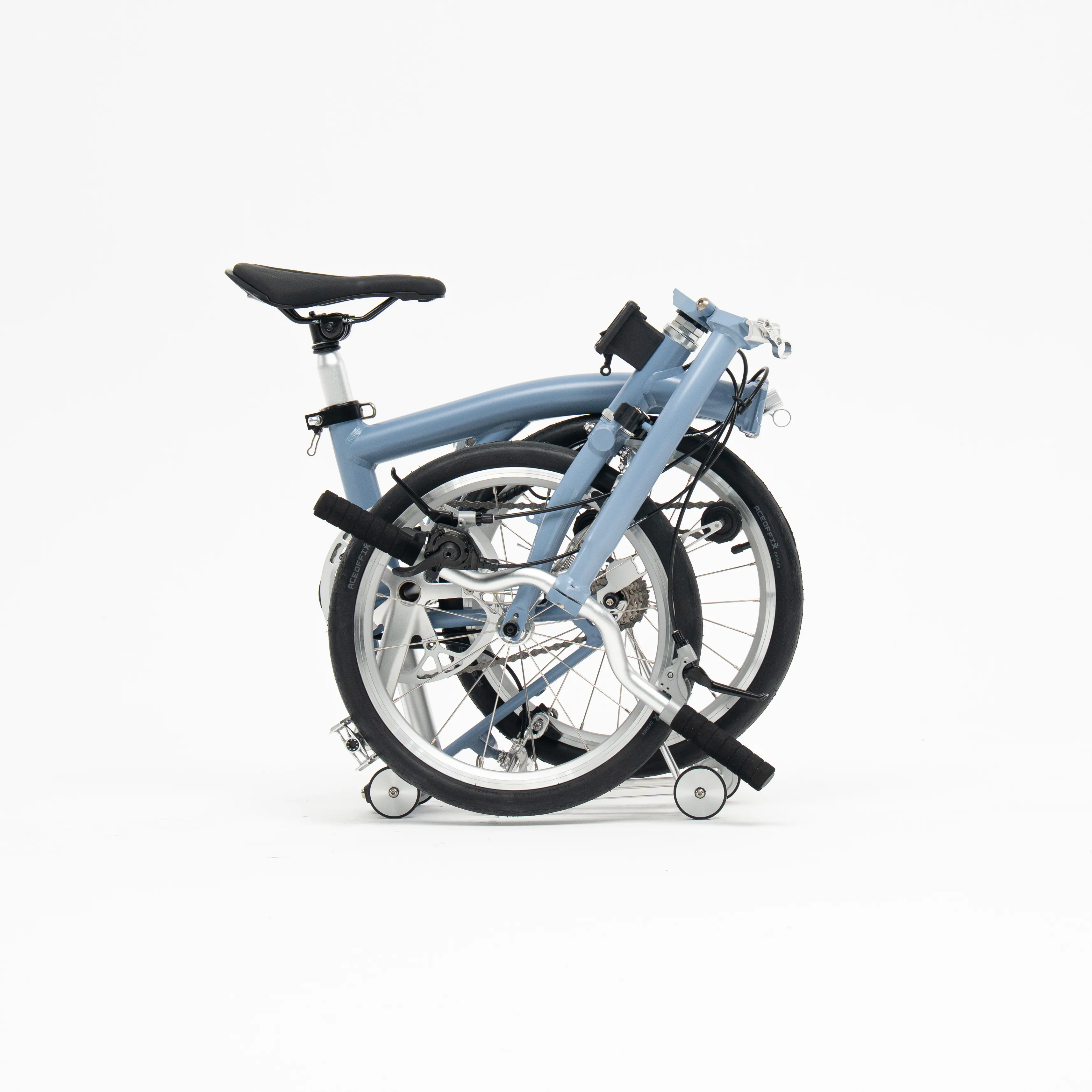 Lumio folding bike, Cloud Blue colourway, folded white-background studio shot