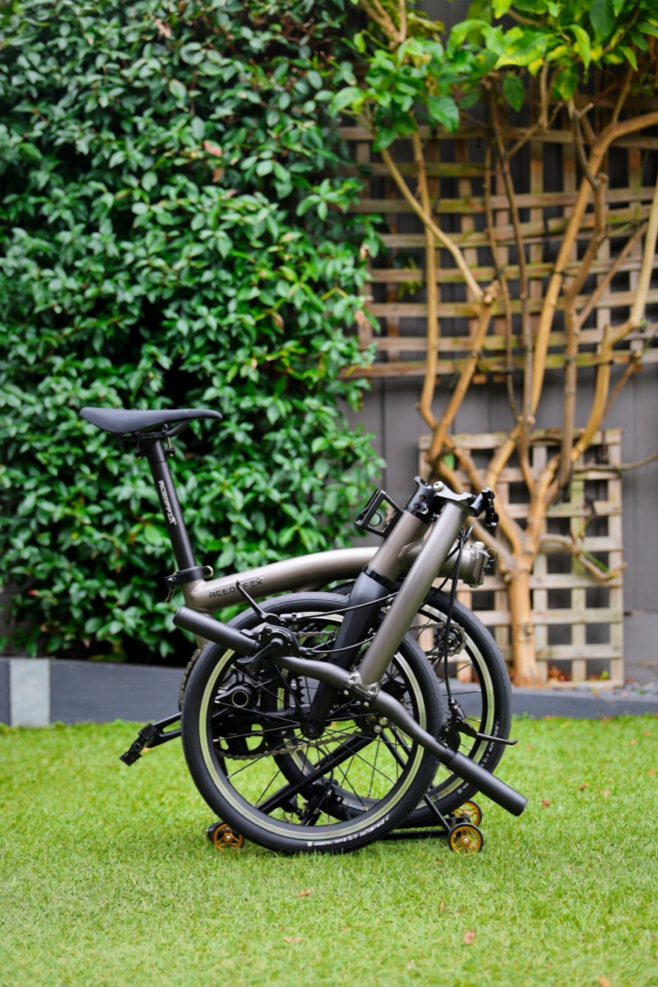 An Aerra folded on grass, showing its compact footprint in a real outdoor setting.